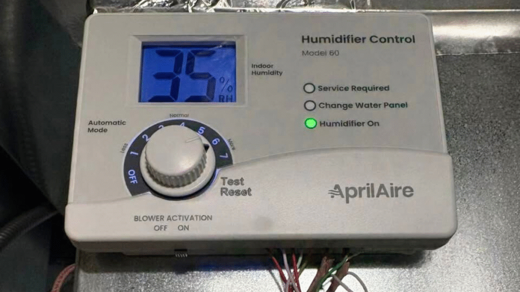 Whole-home humidifier control panel mounted on a furnace in a Central Iowa basement
